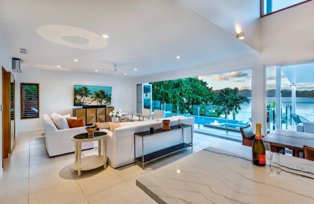 A Living Room With a Bottle of Champagne on the Counter — Coral Coast Building & Management in Cannon Valley, QLD