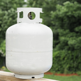 a white gas cylinder with a hole in the top of it