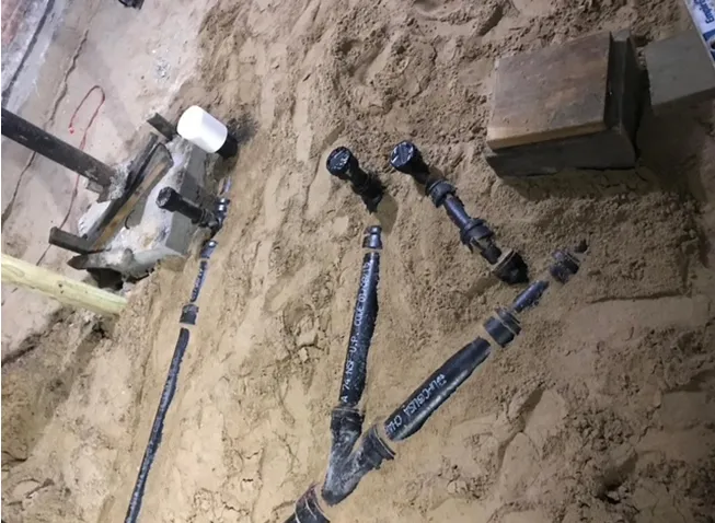 A bunch of pieces of metal are laying in the sand.