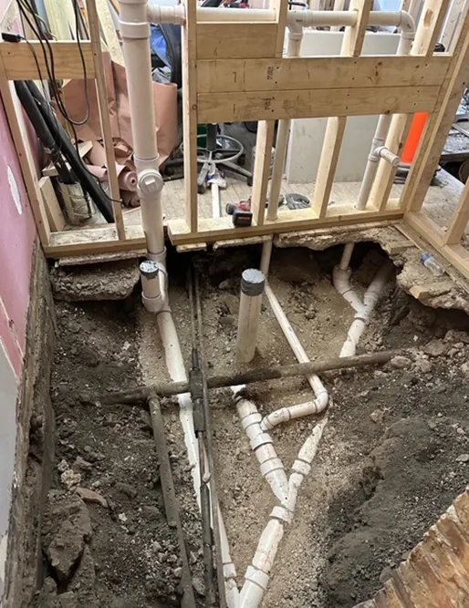 A bunch of pipes are being installed in a hole in the ground.