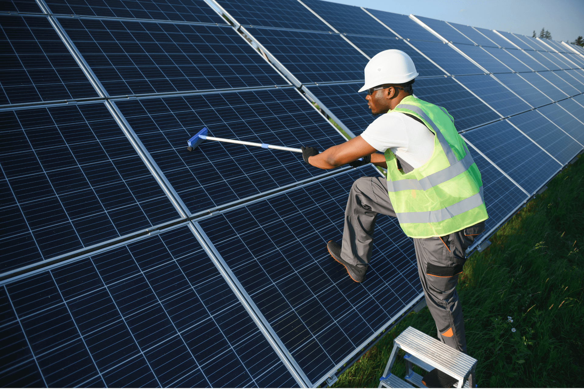 Technician cleaning commercial solar panels