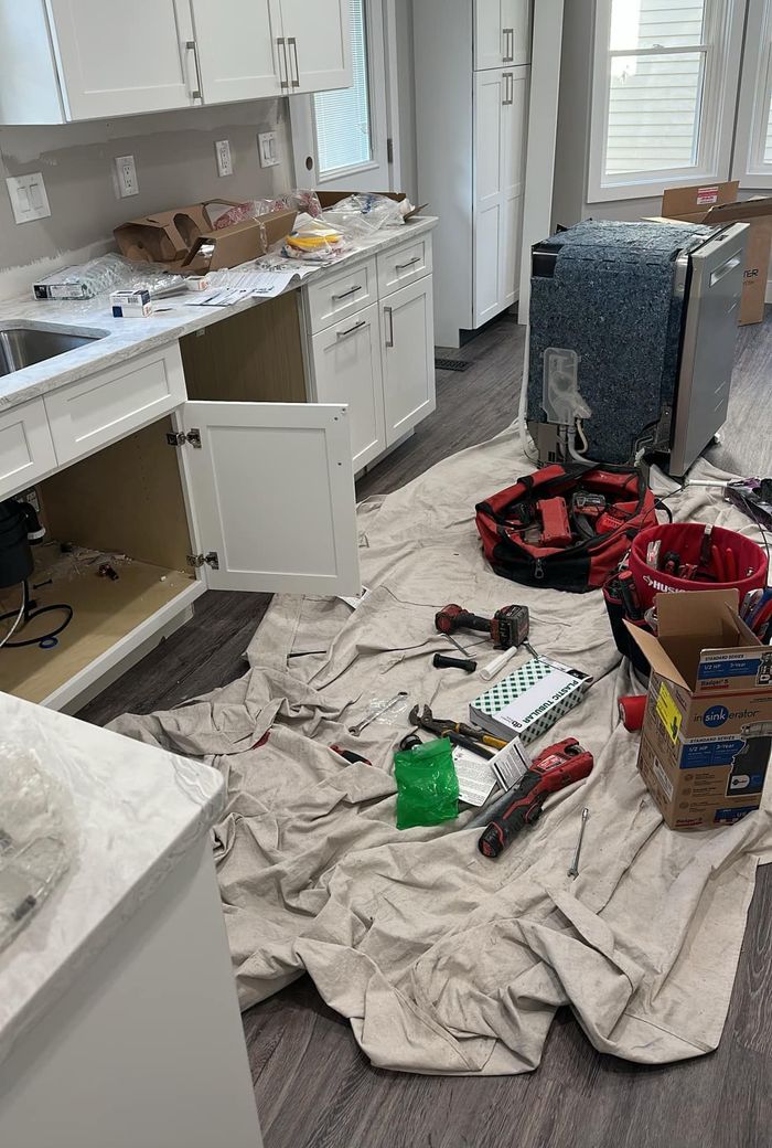 A kitchen under construction with a lot of tools on the floor.