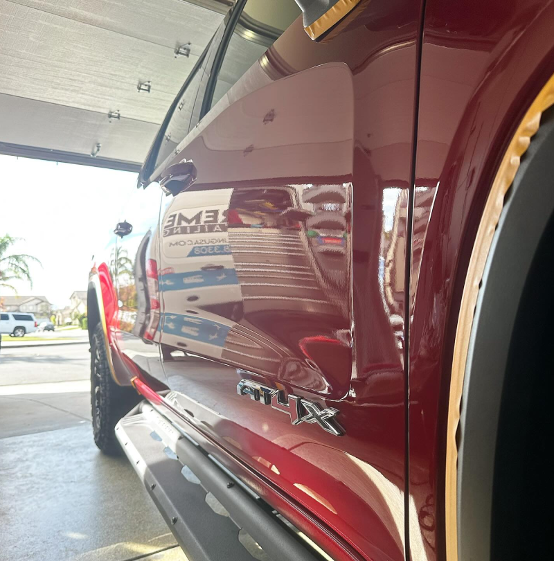 A red truck with the word ram on the side