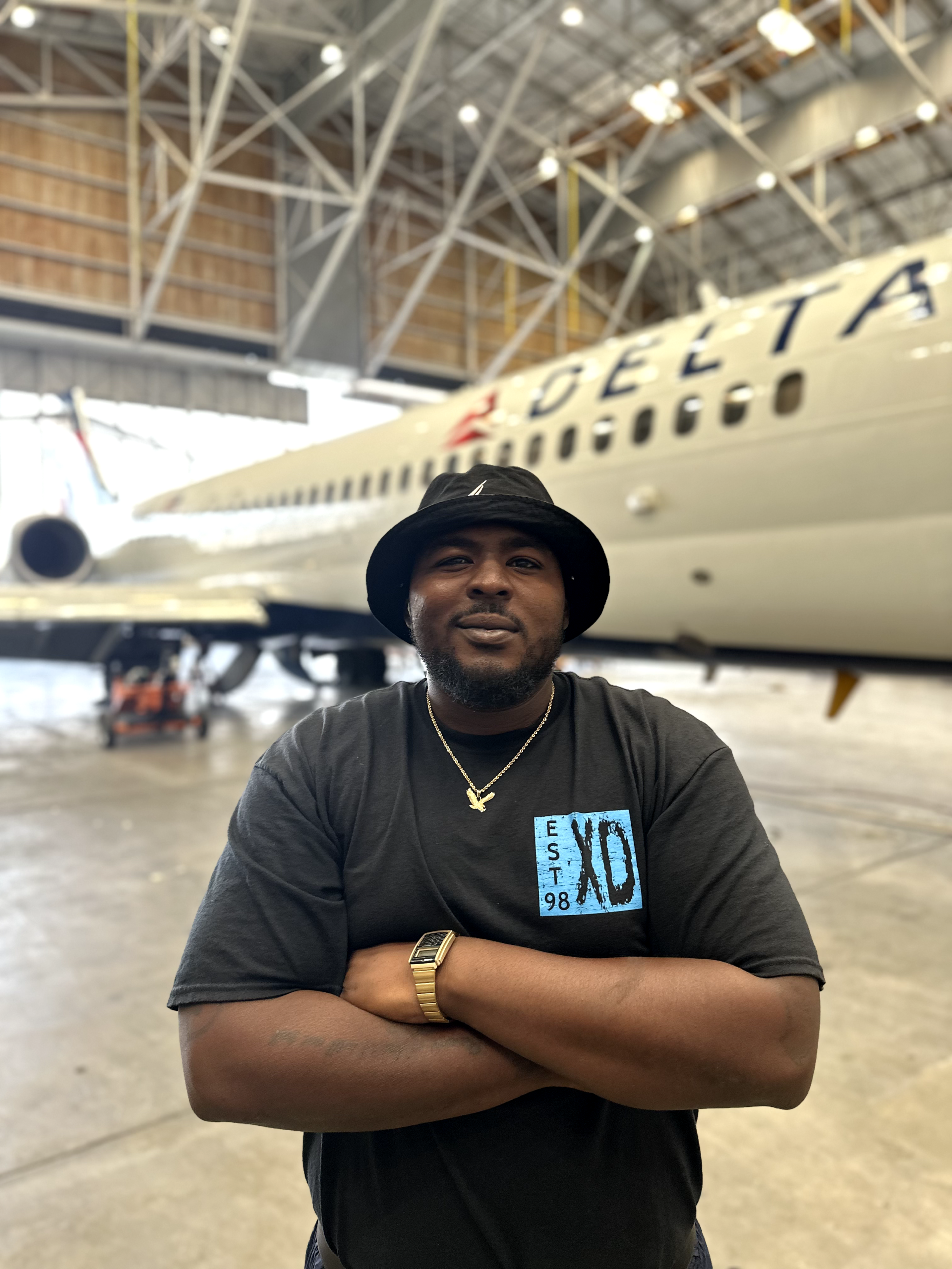 a man is standing in front of a delta airplane