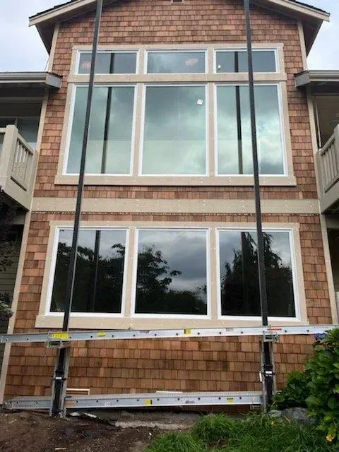 A large house with a lot of windows and a ladder in front of it.