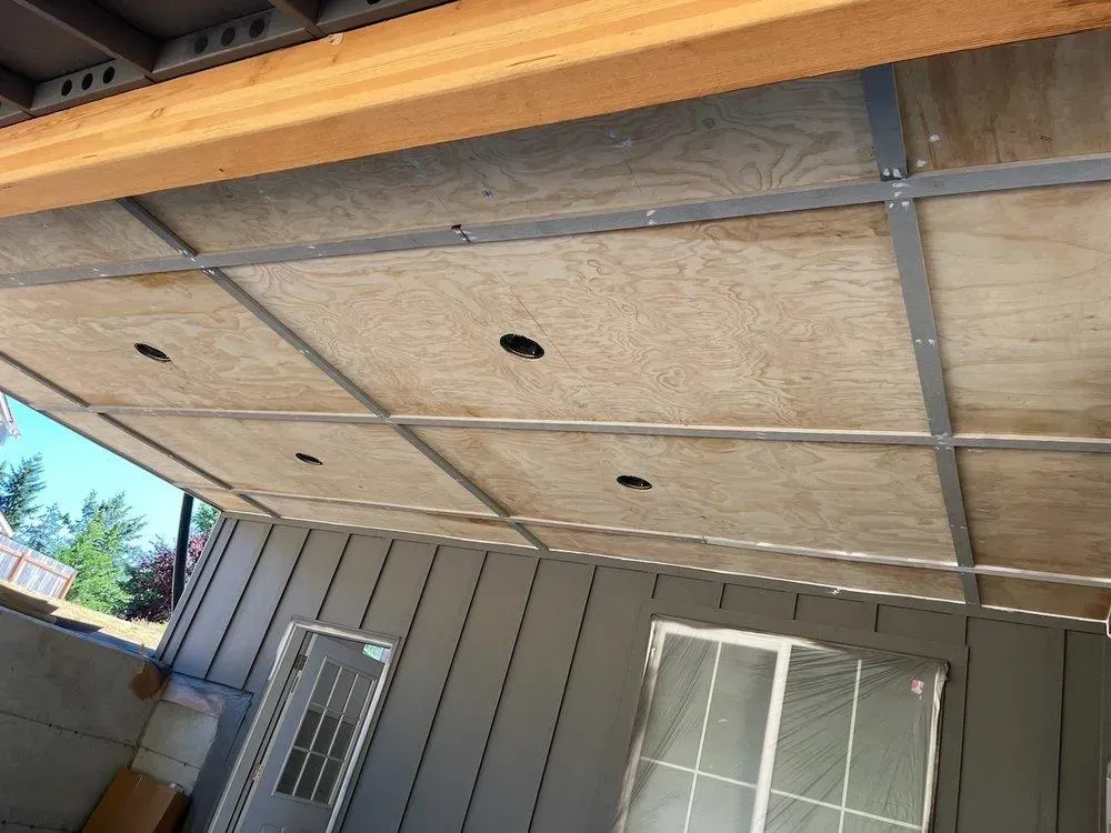 The ceiling of a house is made of plywood and metal.