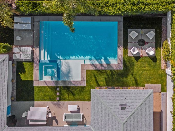 drone shot of modern backyard with pool
