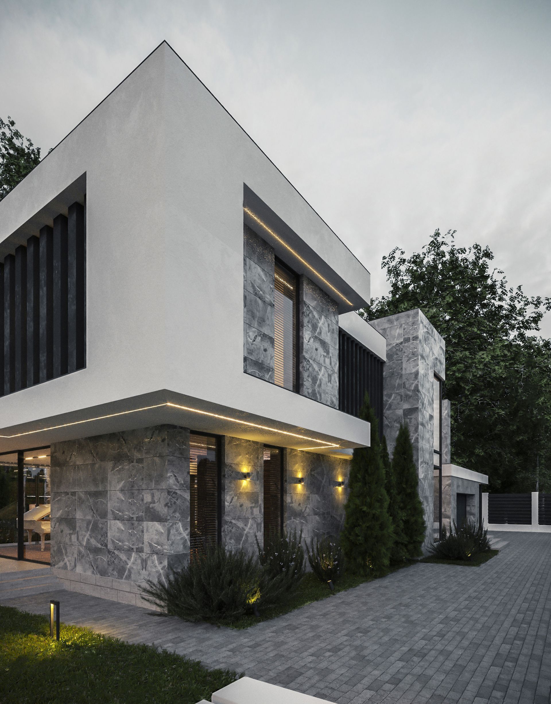 A modern house with a brick driveway in front of it