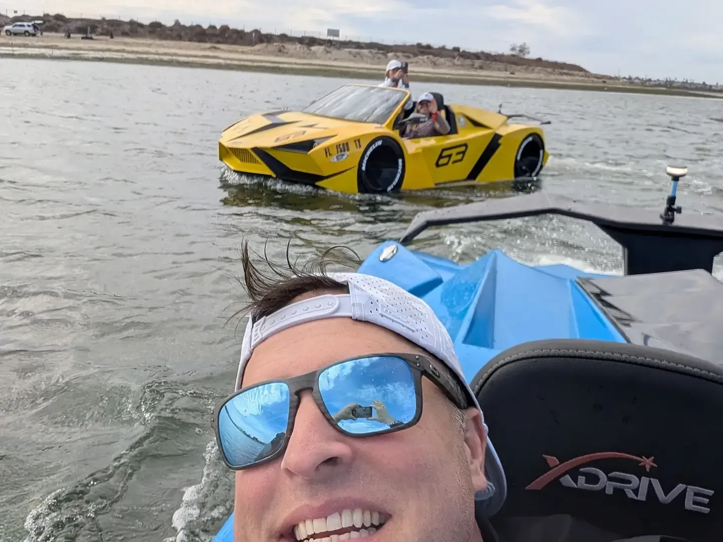 A man wearing sunglasses is sitting in a xdrive boat