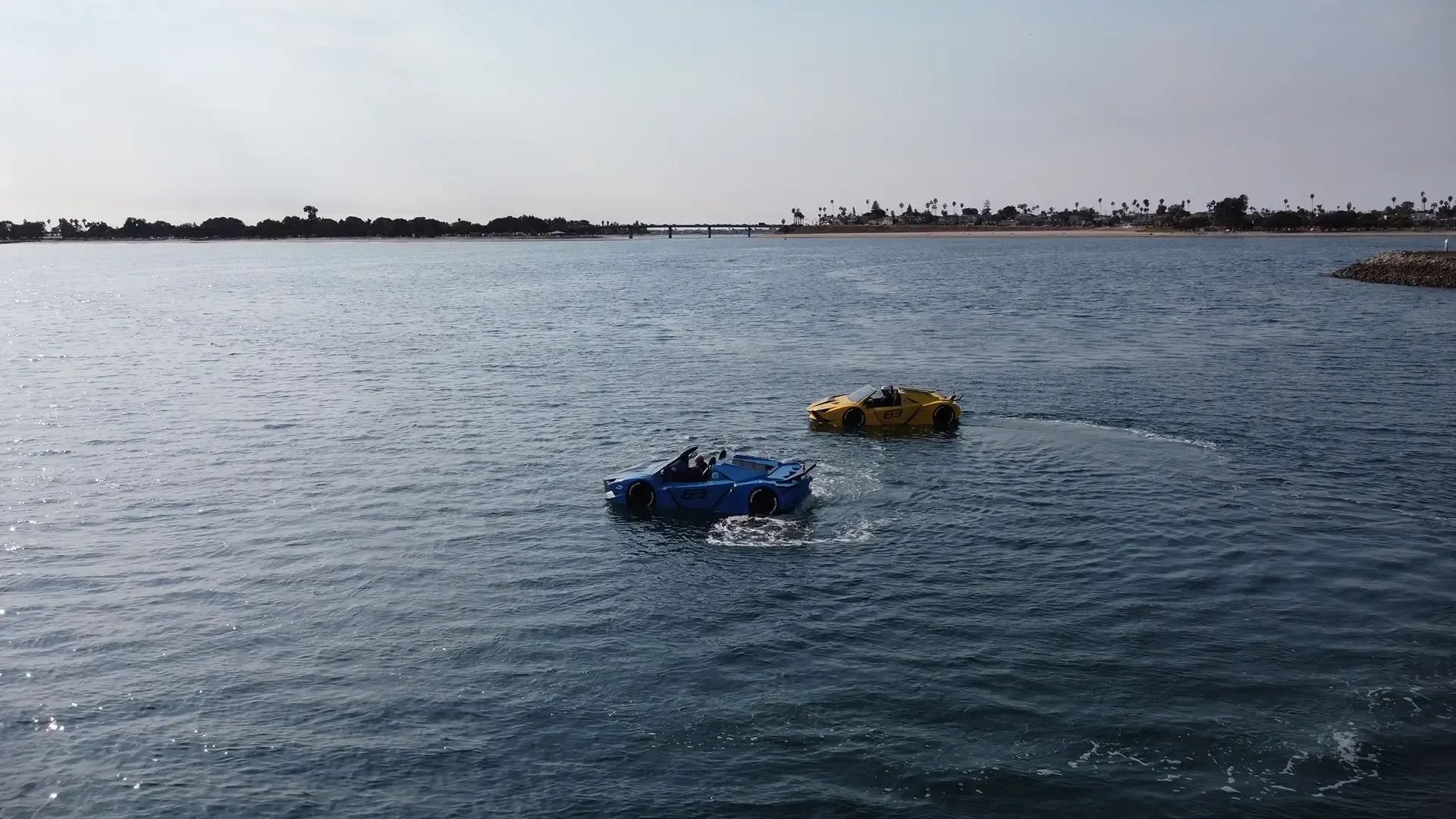Two boats are floating on top of a body of water.