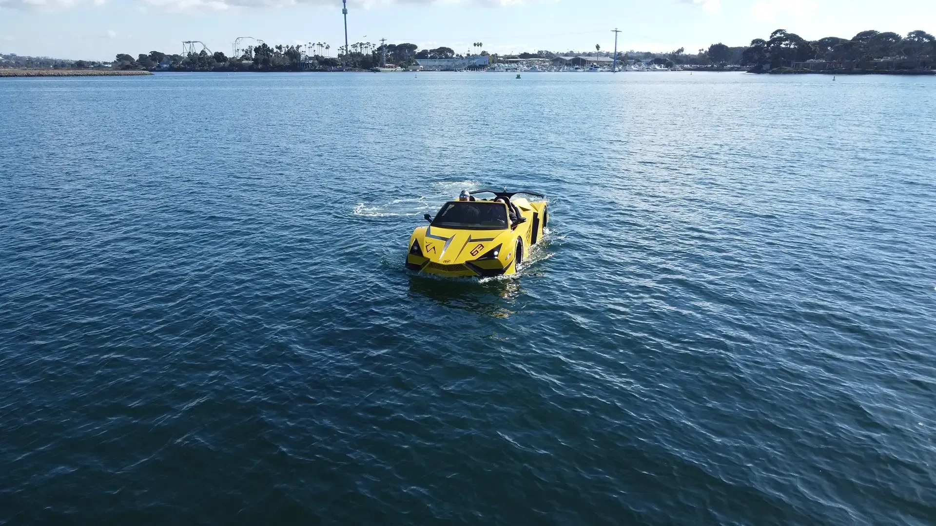 A yellow car is floating on top of a body of water.