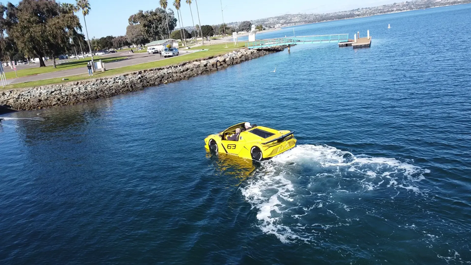 A yellow car is floating on top of a body of water