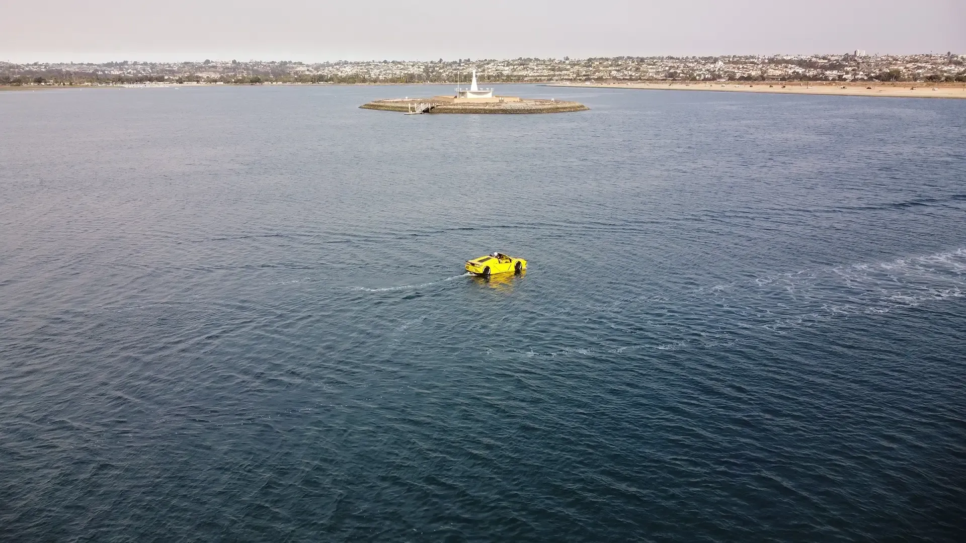A yellow buoy in the middle of a body of water