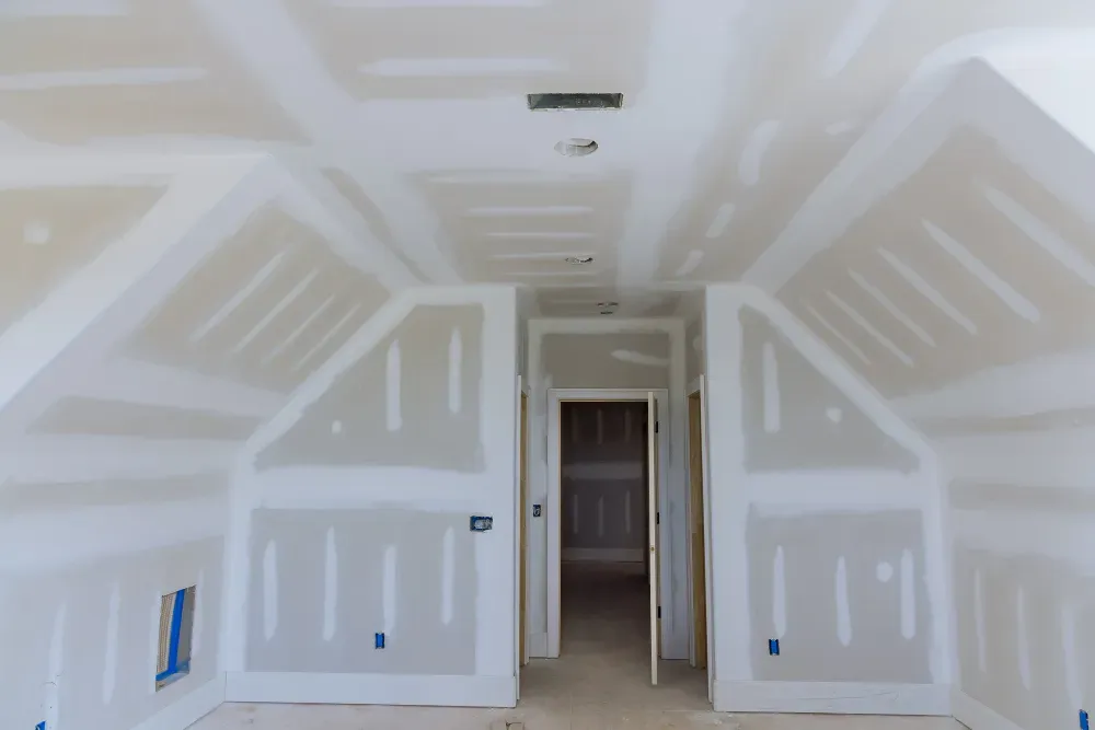 Interior view of a room under construction with drywall installed on walls and ceiling in Huntley, IL