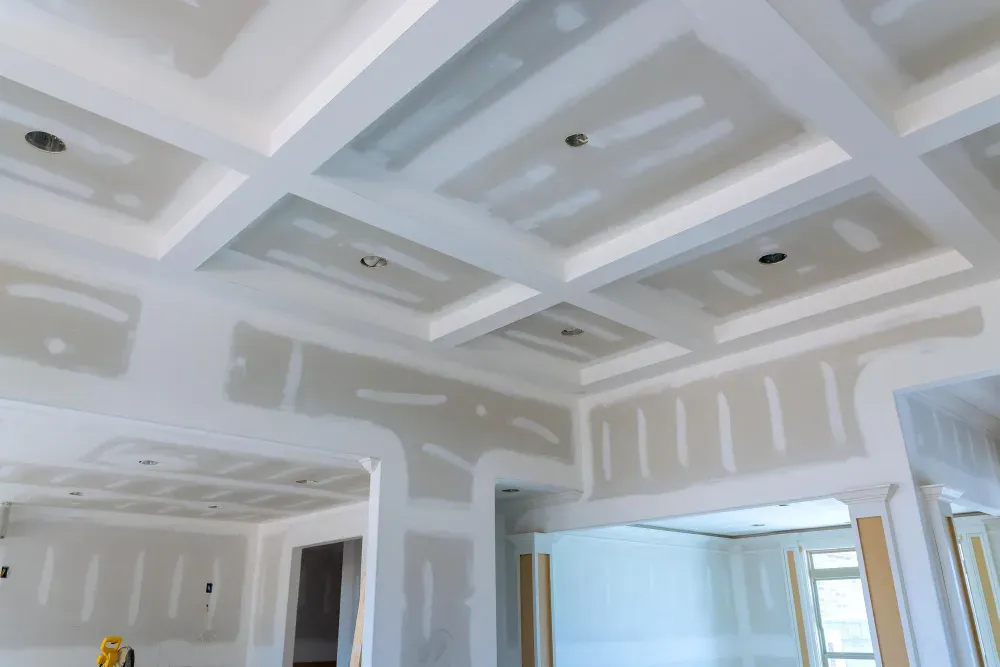 Drywall ceiling construction in a house with a coffered design; light gray in Huntley, IL