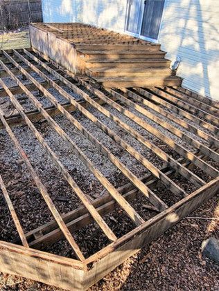 A wooden Pergola is being built in front of a house in Lindenhurst, IL.