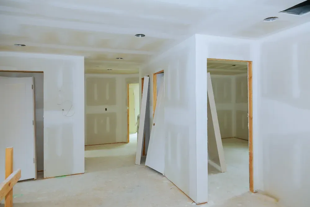Interior of a building under construction, showing drywall walls and door frames in Huntley, IL