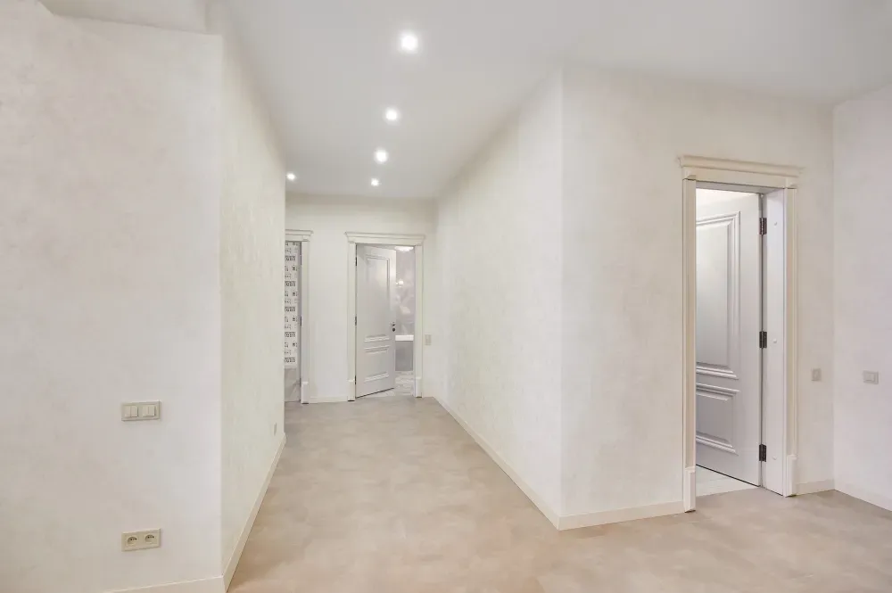 Empty hallway with white walls, recessed lighting, and doors in Huntley, IL