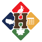 Man with brown hair and beard, smiling. Wearing a patterned shirt and brown blazer. Against a blue backdrop.