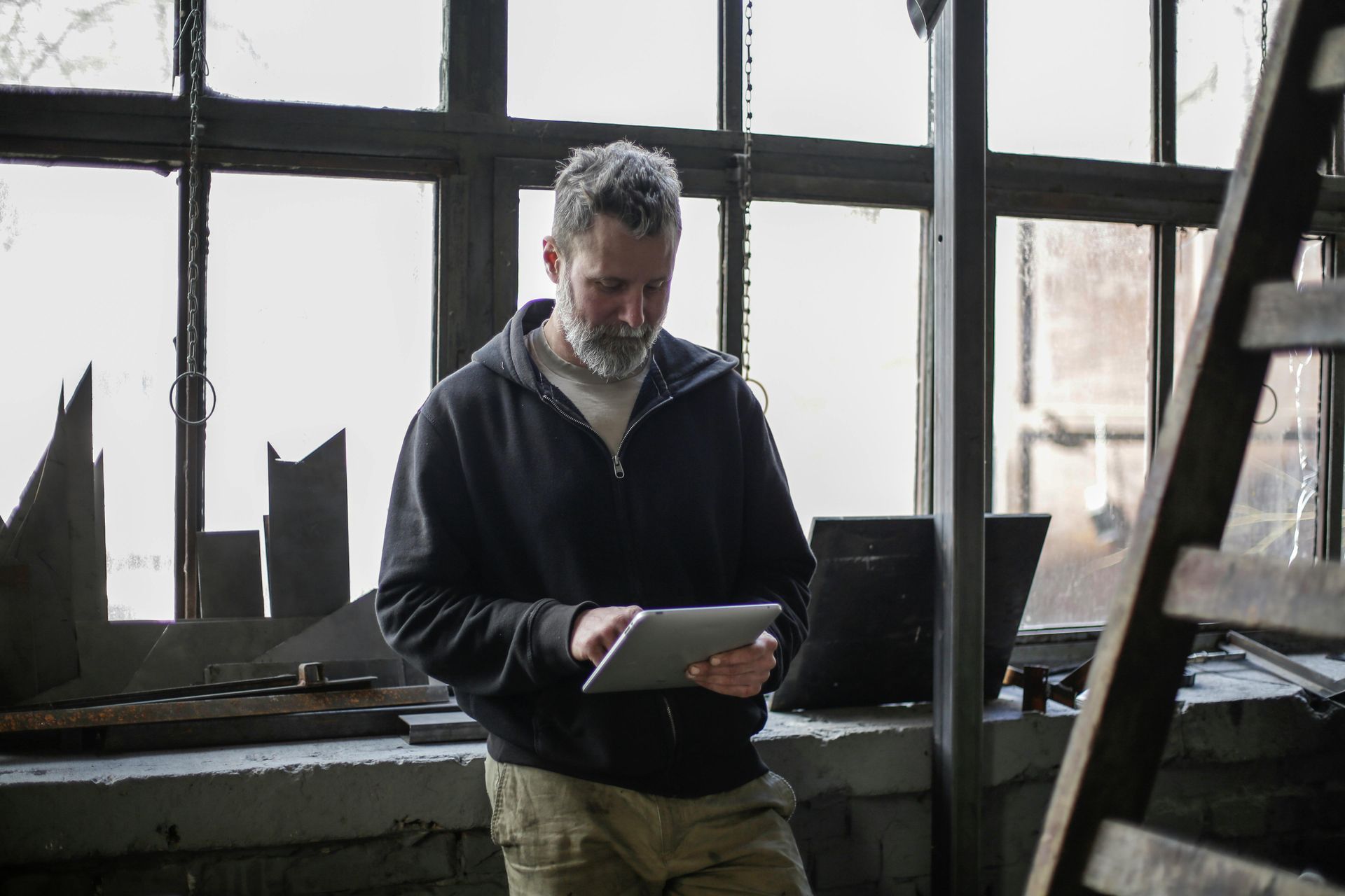 Field technician using GNSS-enabled tablet with Survey123 form and live sync status