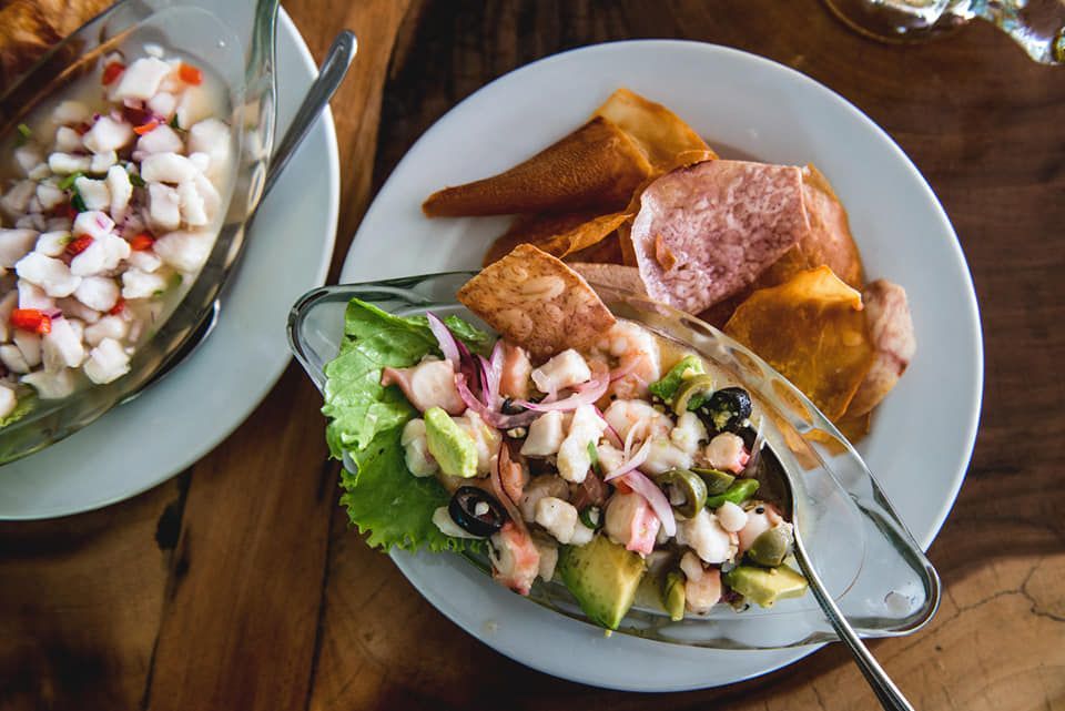 Two plates of food are sitting on a wooden table.