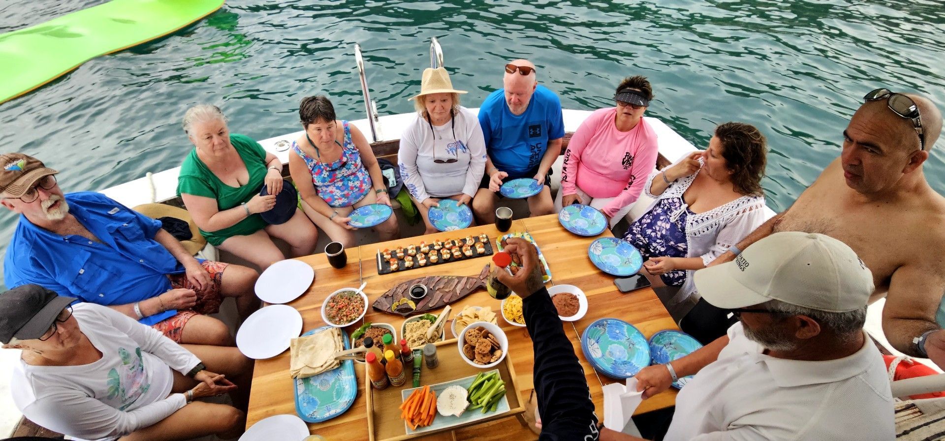 A group of people are sitting around a table in the water.