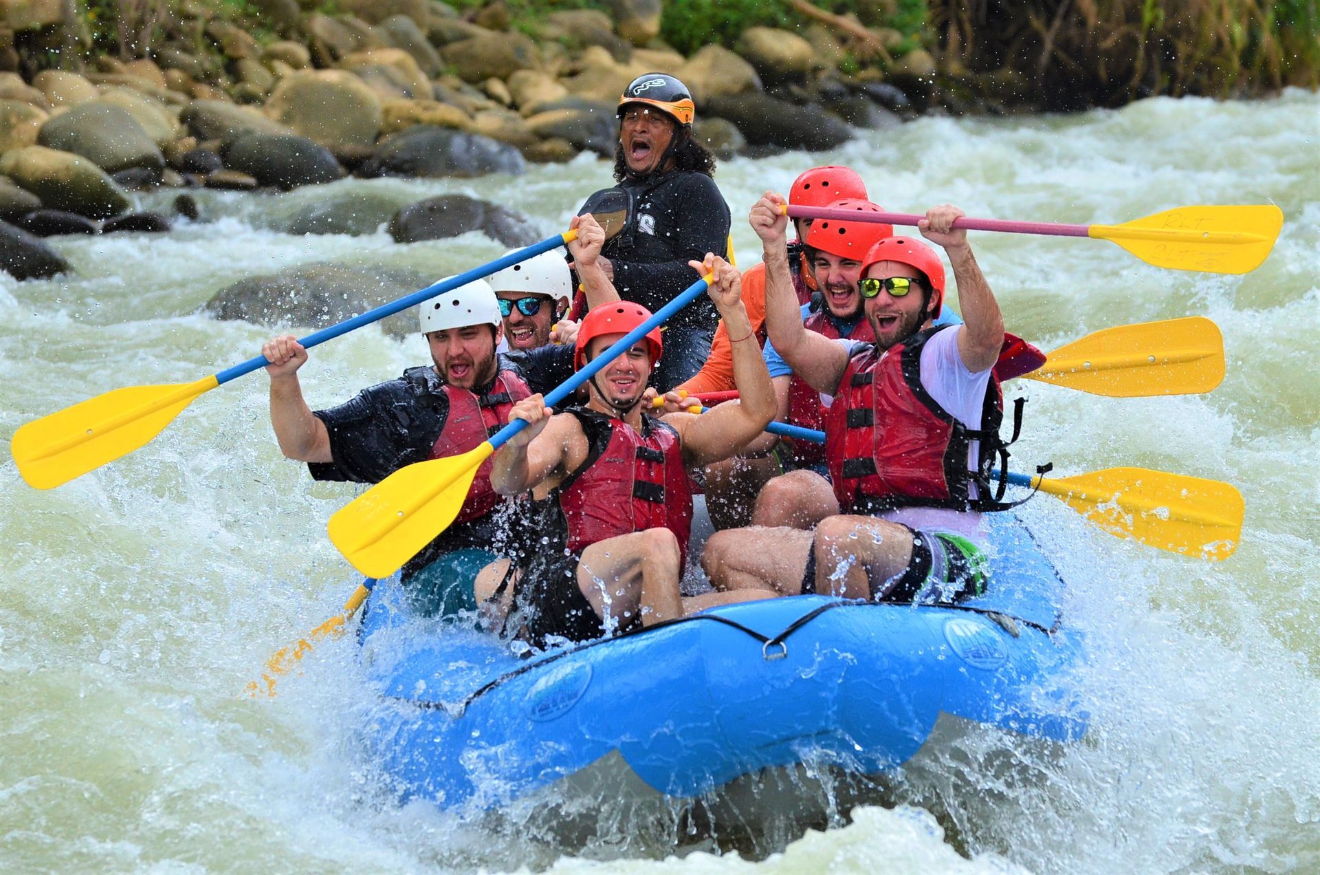 A group of people are rafting down a river in a raft.