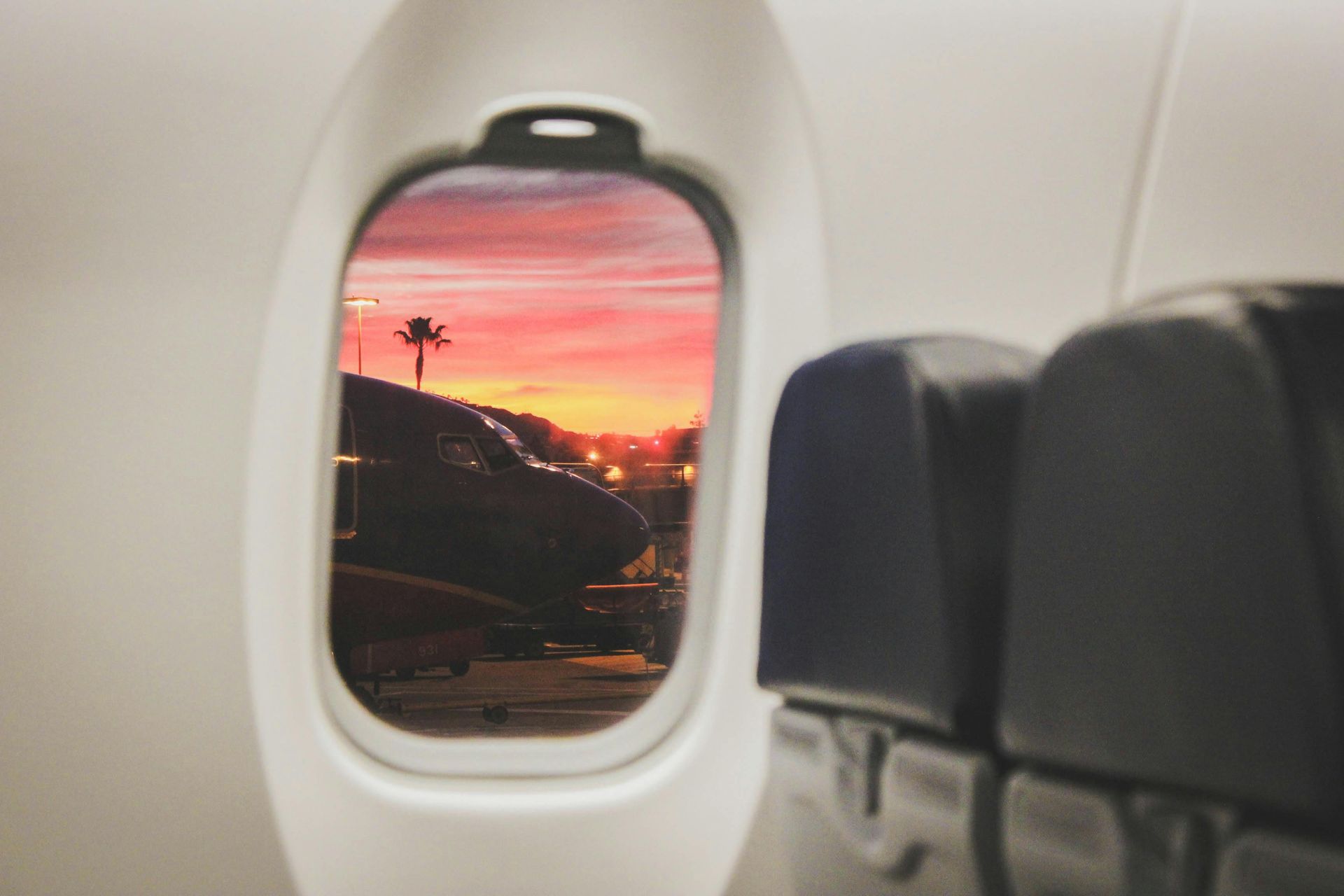 A view of a sunset from the window of an airplane.