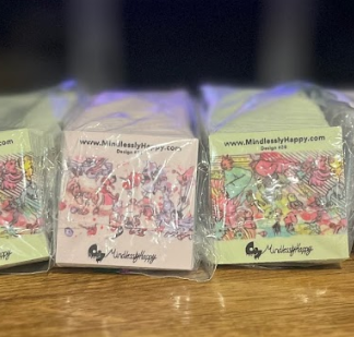 A bunch of cards are sitting on top of a wooden table.