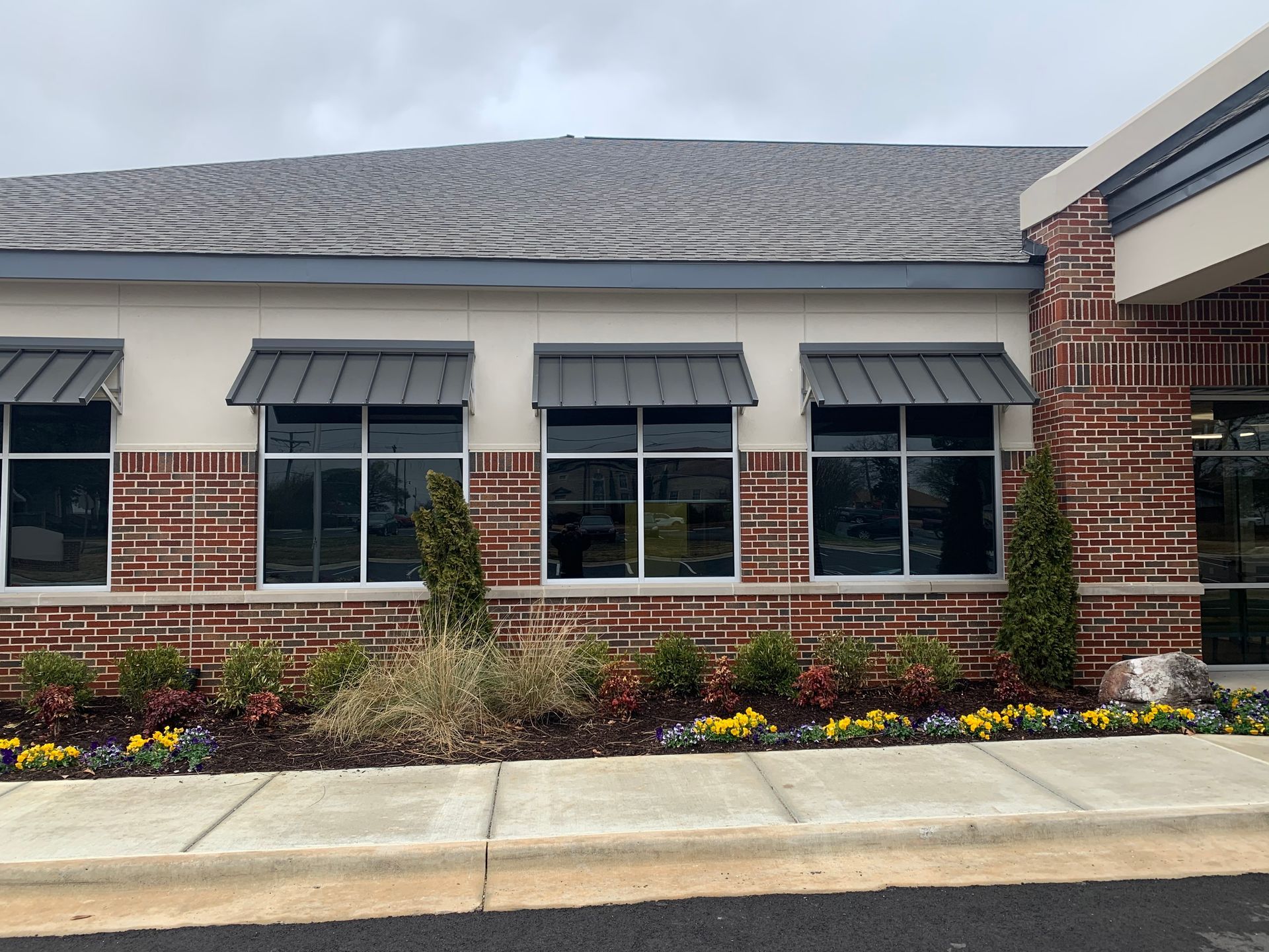 A brick building with a lot of windows and awnings