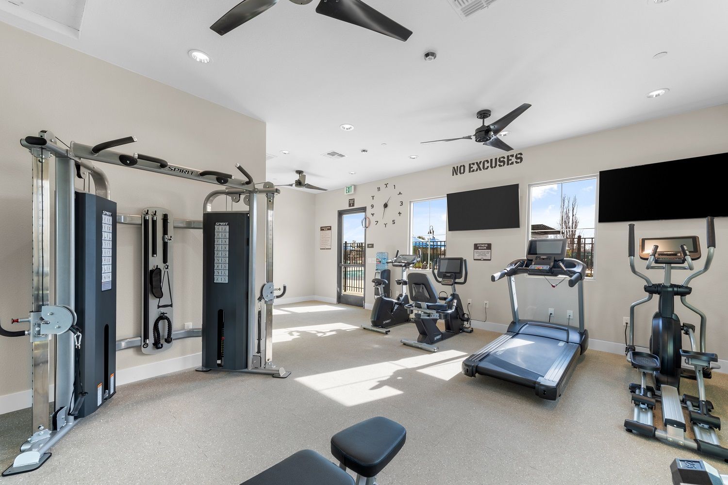 Indoor apartment fitness center with cardio machines and a weight station. Imagine mornings at The Silvergate.