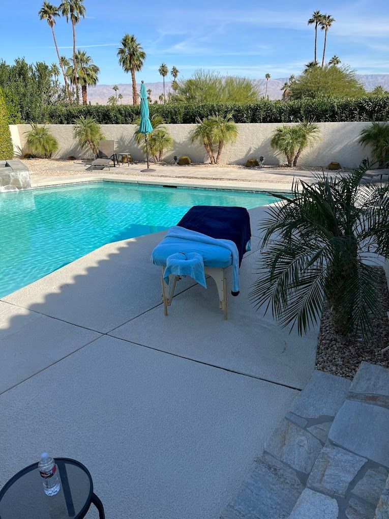 A massage table is sitting next to a swimming pool