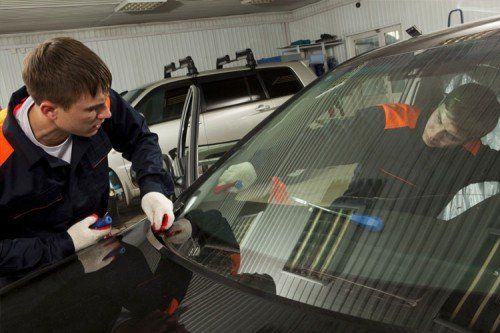 Man fixing windshield - Locksmith Services in Wareham, MA