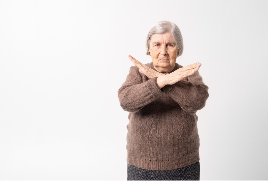 Elderly women with arms in a cross shape