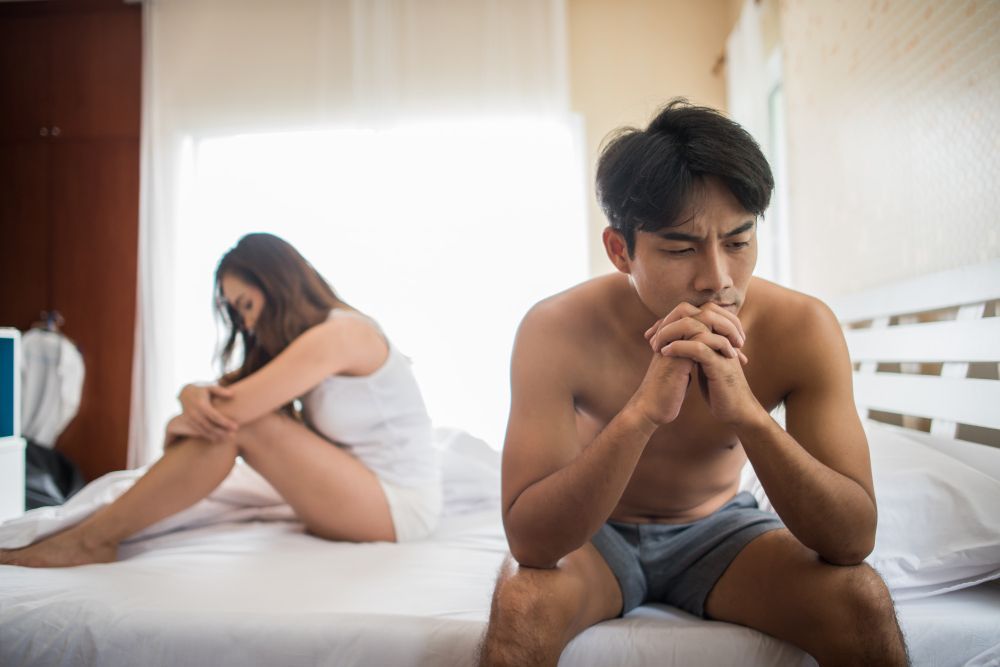 Depressed Man Sitting on the Bed