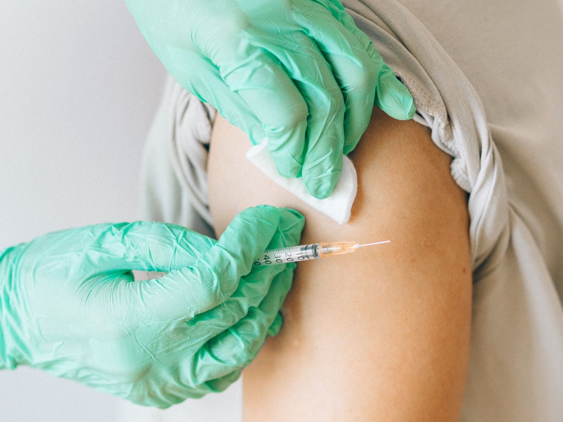 A person is getting a vaccine in their arm.