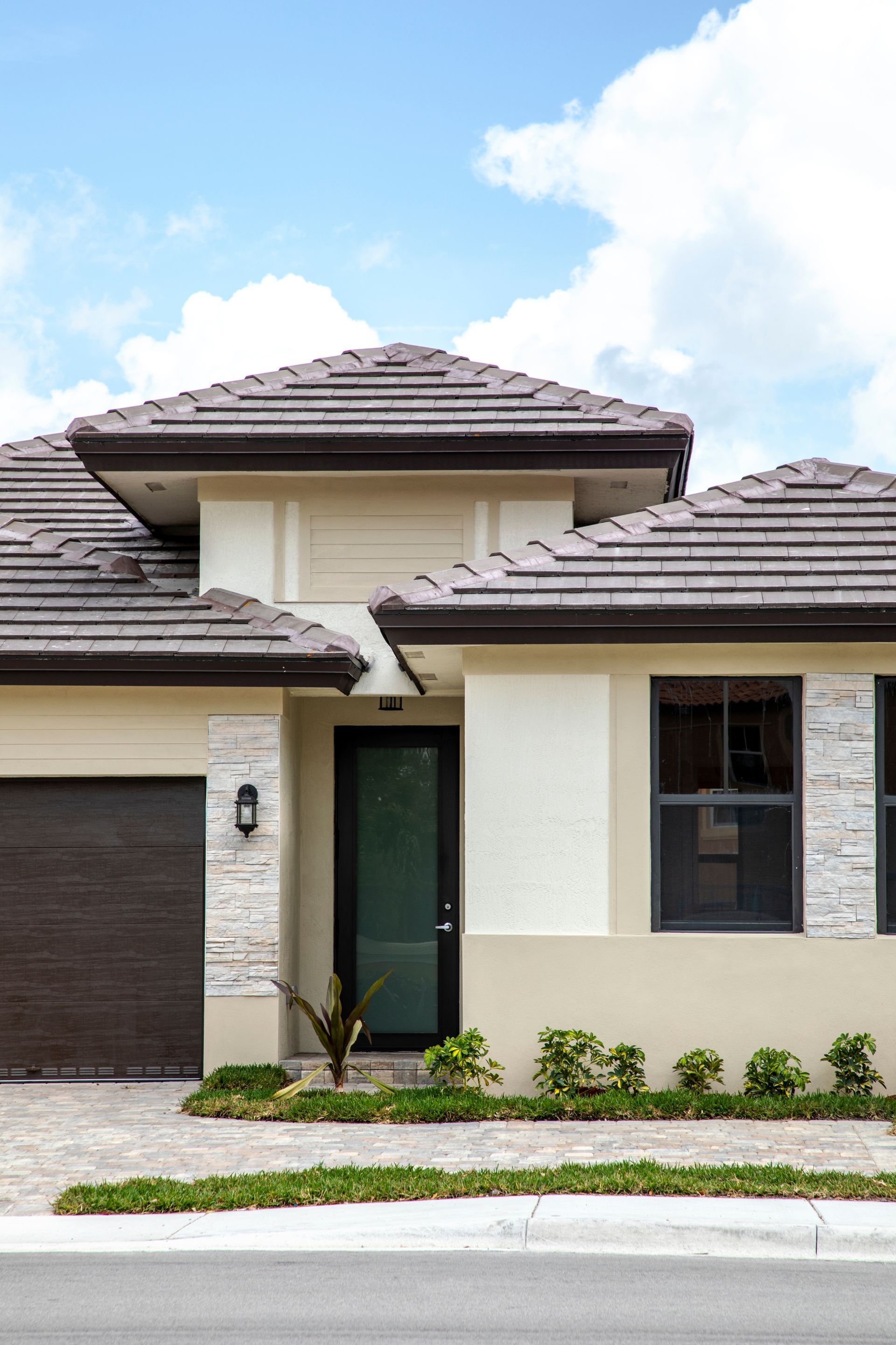 A close-up of a warm, orange-toned wooden wall featuring horizontal log-like planks with a vertical seam and a latch.