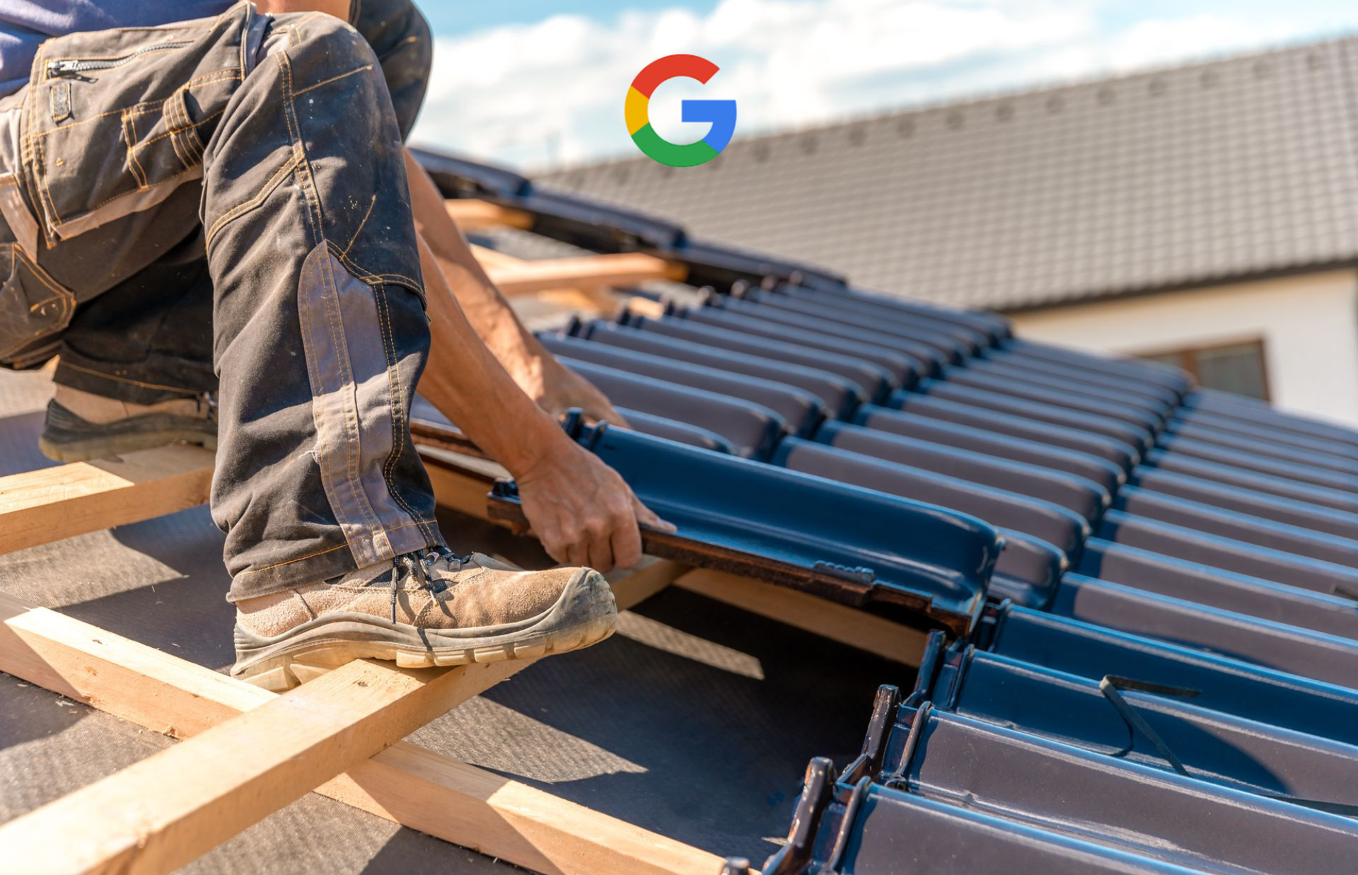 A roofer installs dark, textured roof tiles on a wooden frame structure during a sunny day.