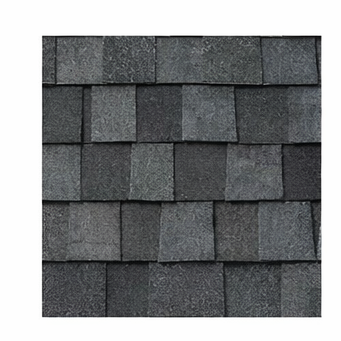 A close-up view of dark gray architectural asphalt roof shingles layered in a staggered pattern.