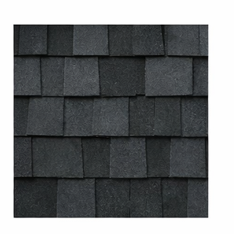 A close-up view of dark grey asphalt roof shingles overlapping in a standard pattern.