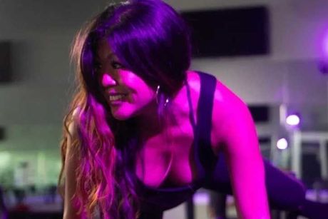 woman  in a gym under purple lights.