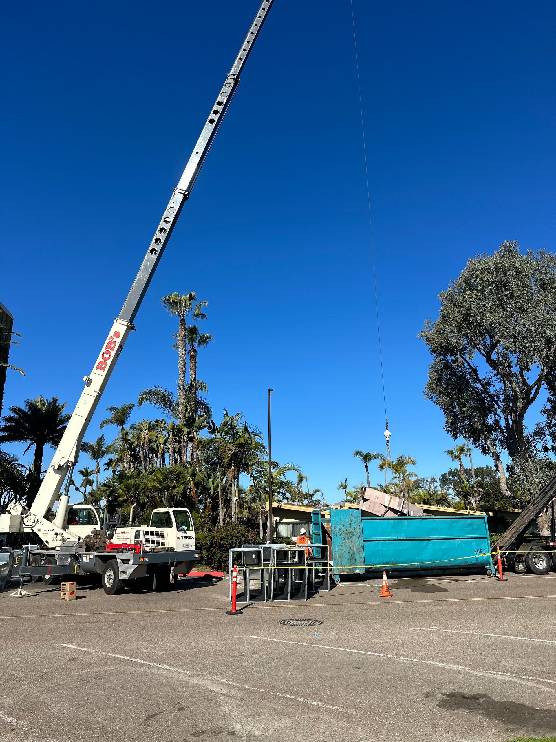 A large crane is sitting in a parking lot