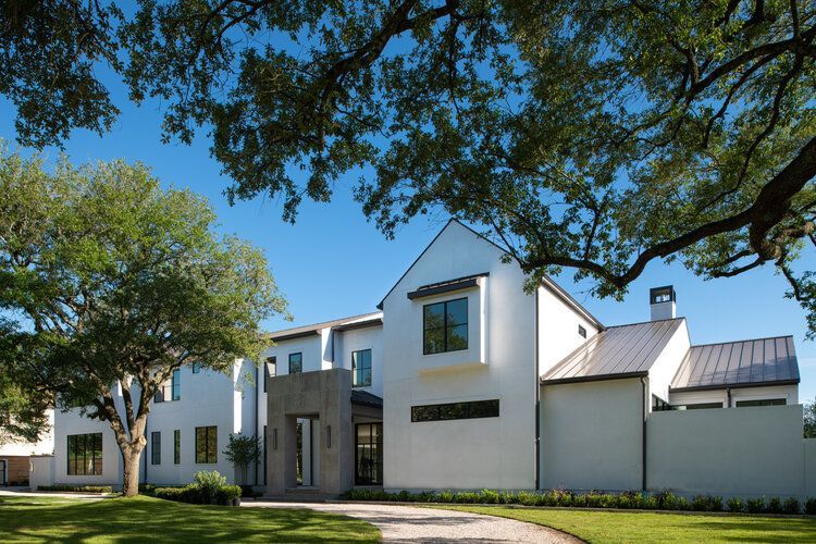 A large white house with a tree in front of it