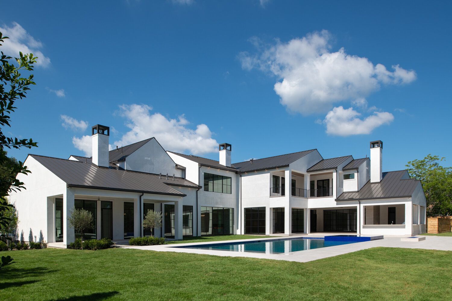 A large white house with a swimming pool in the backyard