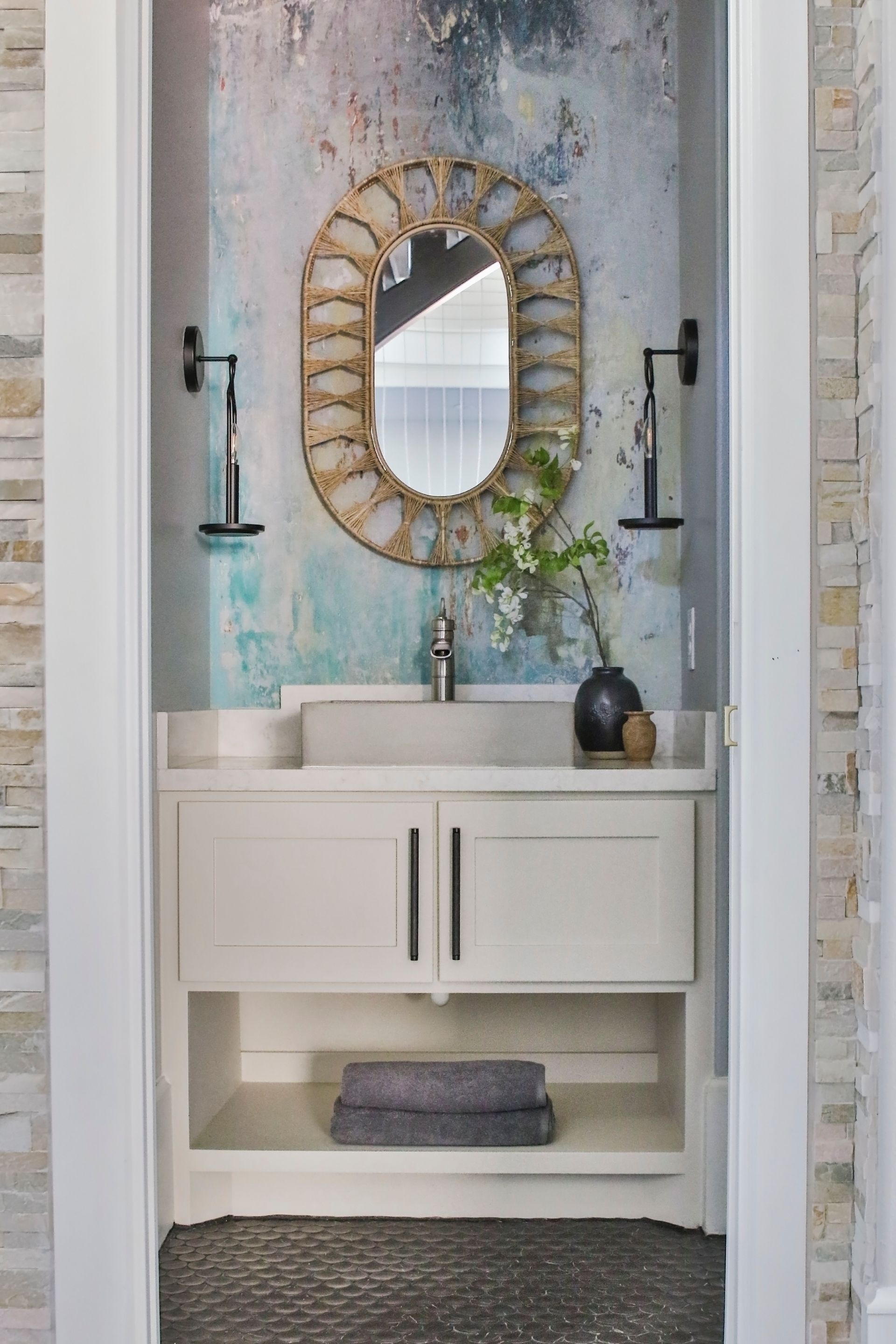 A bathroom with a sink and a mirror on the wall.