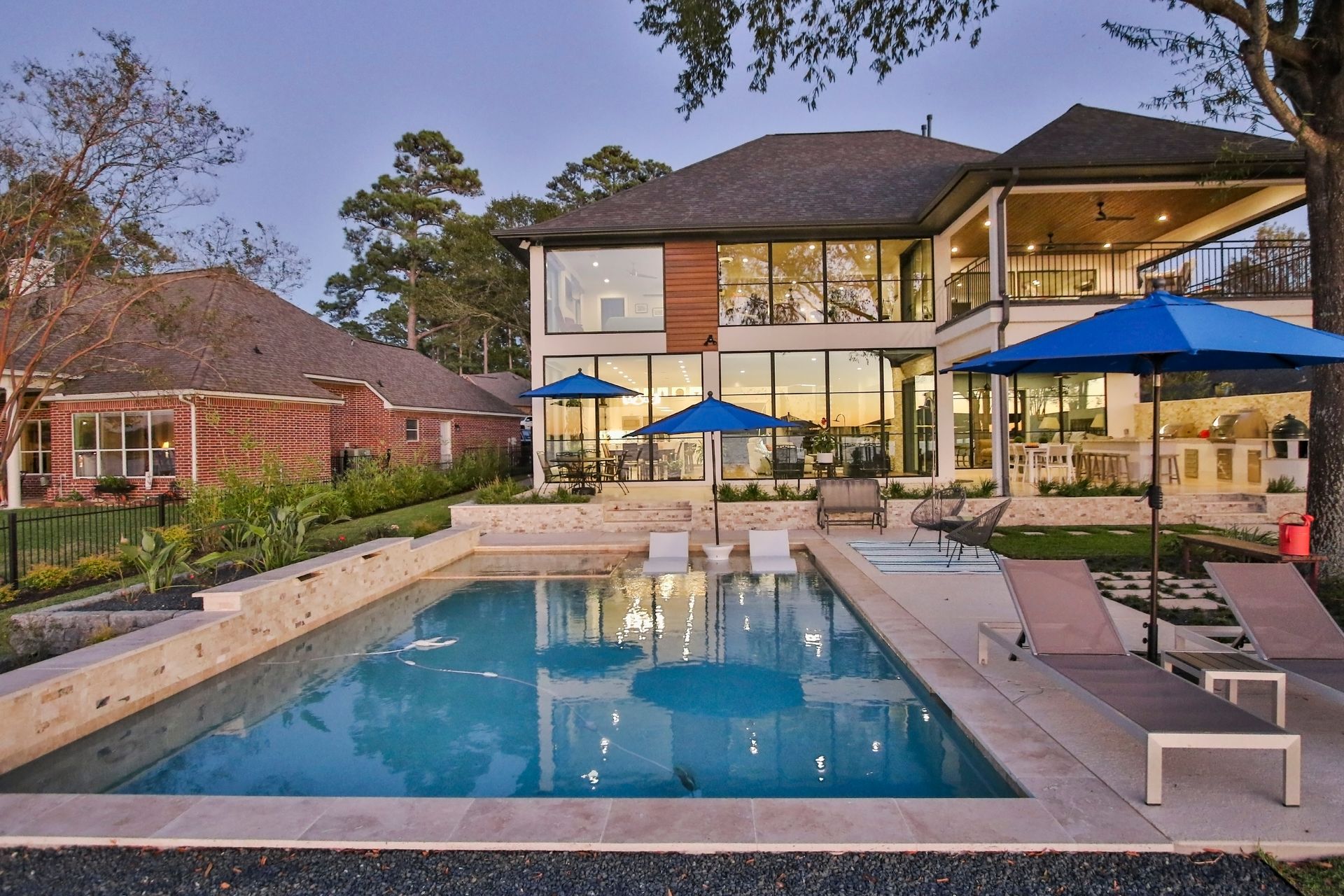 A large house with a large swimming pool in front of it