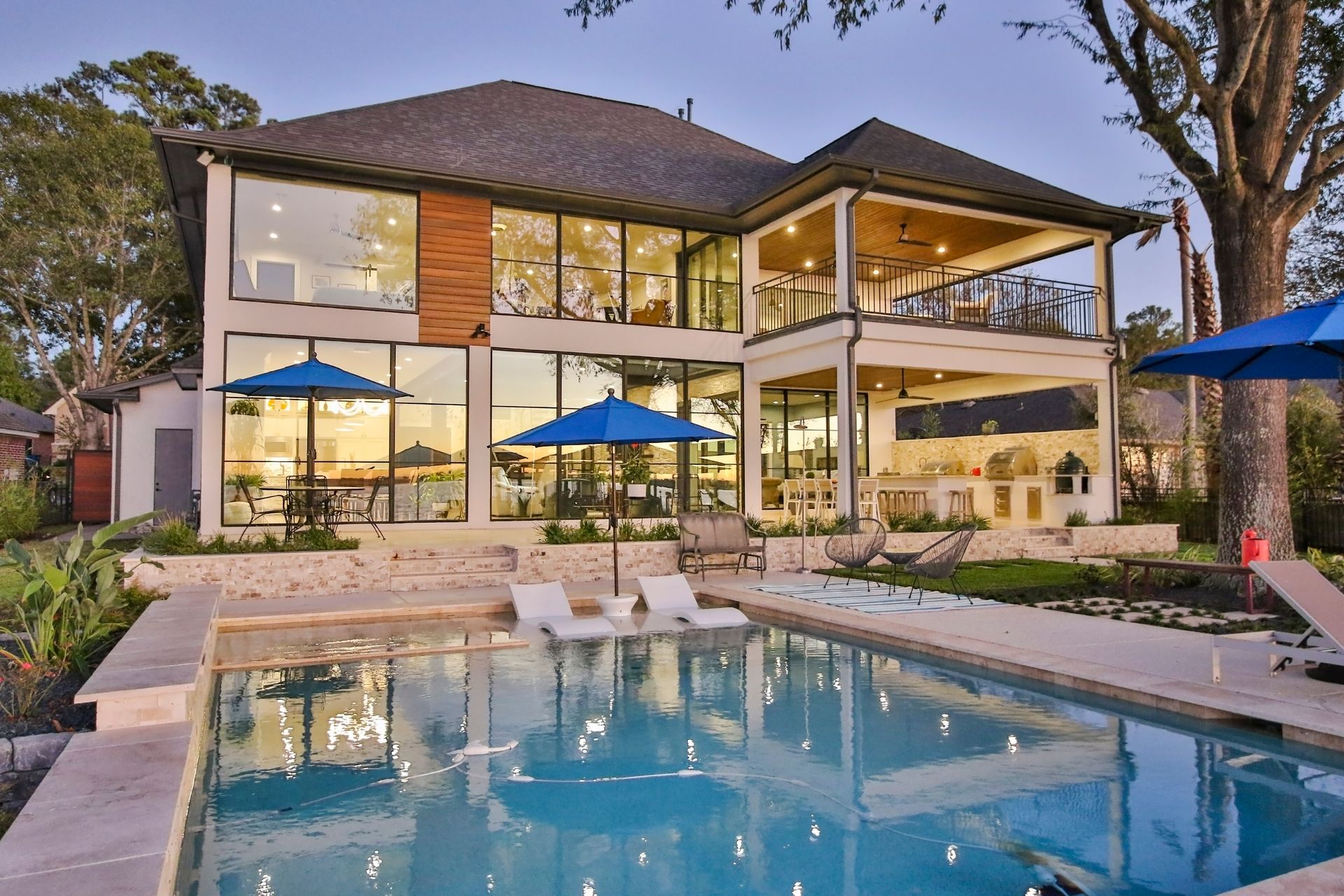 A large house with a large swimming pool in front of it