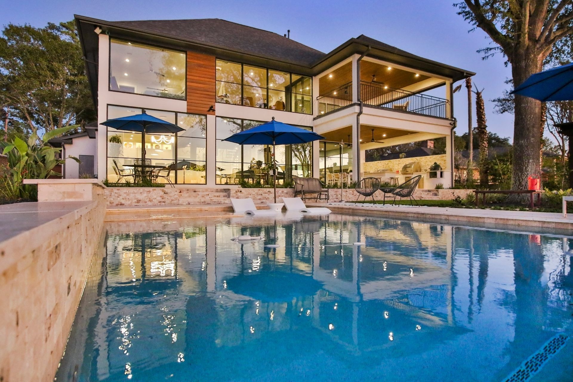 A large house with a swimming pool in front of it