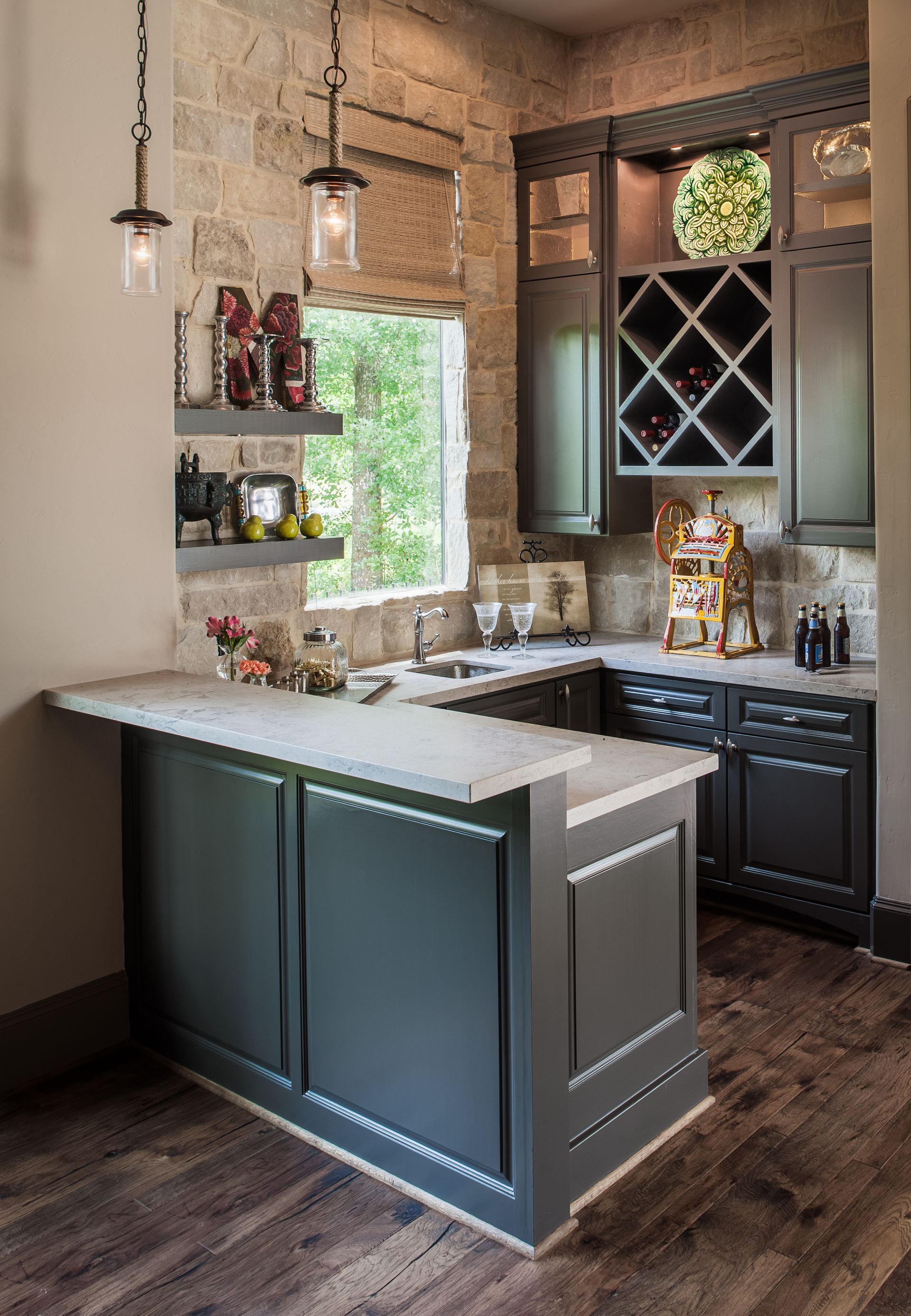A kitchen with a bar and a wine rack