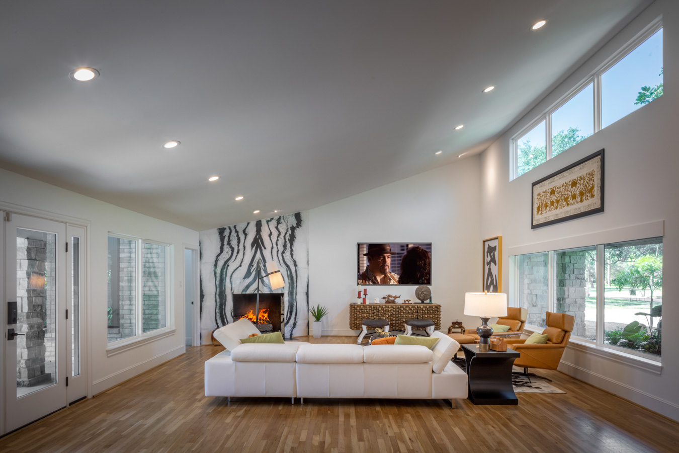 A living room with a white couch and a fireplace.
